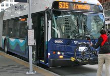 Refining I-405 BRT, Sound Transit Seeks Input on Station Access and Amenities A person loading a bike on a Sound Transit bus, a Route 535 headed to Lynnwood.