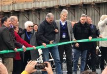 Inslee’s Climate Proposal: Necessary, but Don’t Call It Bold Inslee holds the scissors and other high-level officials look on outside the SR-99 tunnel in February 2019.