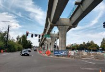 Metro Delays Park-and-Ride Redevelopment Plans, Save for 232 Affordable Homes Elevated light rail with pylons next to a street in Northgate.