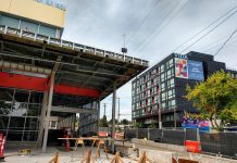 Hackney Bill Offers Seattle a Path to Fund Rail Priorities Roosevelt light rail station entrance with a 6-story apartment building in the background.
