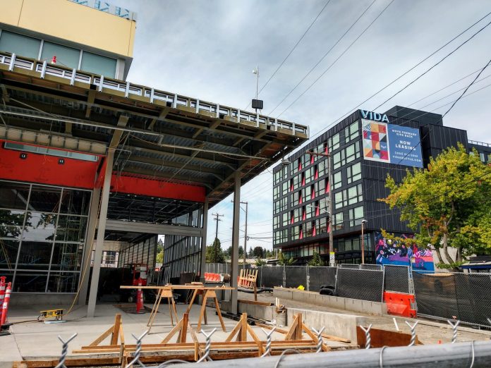 Roosevelt light rail station entrance with a 6-story apartment building in the background.