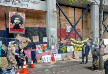 Hesitant Councilmembers Thwart ‘No New Cops’ Solidarity Budget The memorials along the East Precinct police station--now christened the Capitol Hill Community Center--keep growing. (Photo by Doug Trumm)