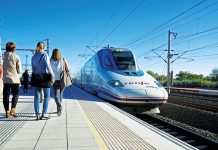 High-Speed Rail Benefits Small Towns and Large Cities An high-speed train pulls into a station and passengers approach. (Photo courtesy Midwest High Speed Rail Association)