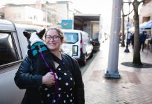 2020 Endorsement Questionnaire: Jessi Murray, LD43-2 Jessi Murray poses on the sidewalk with her dog in her arms.