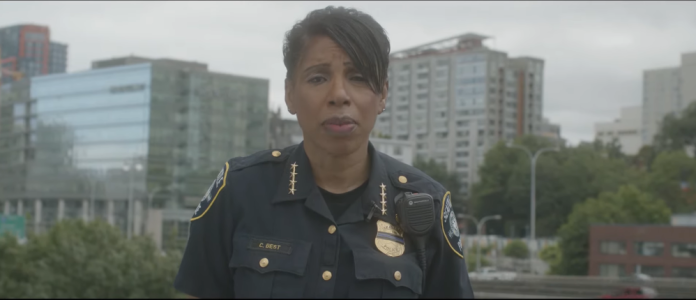 Chief Best in SPD video Chief Best with a Downtown Seattle buildings and street behind her. Video is here: https://www.seattle.gov/police/together