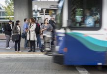 Policy Lab: Shifting Transportation Habits with Cold, Hard Cash Seven passengers wait to board a Sound Transit bus. (Photo courtesy of Sound Transit)