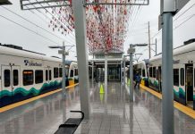 Sound Transit Prepares to Unpause Nine Project Actions and Moves to Surplus Angle Lake Properties two trains at a station with little glass orbs sculpture overhead