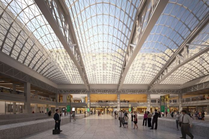 Moynihan Train Hall empire-station-complex-2016-02.rhorizontal.w700 An airy train station with a glass ceiling held by steel latticework.
