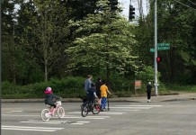 SDOT Explores Mobility Improvements Near 130th and 148th Street Light Rail Stations A family on bikes crosses a 130th Street crosswalk.