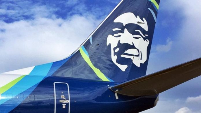 Alaska Airlines Plane The Alaska Airline logo on the fins with the blue skies and clouds in the background.