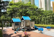 Social Housing Skeptics Are Full of It A playground with trees and public housing towers in the background