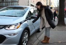 Macri Bill Proposes Banning New Fossil Fuel Cars in 2030 A women charges an electric sedan.