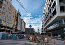 Growing Social Housing in Seattle Seven-story midrise apartments along a pedestrian plaza.