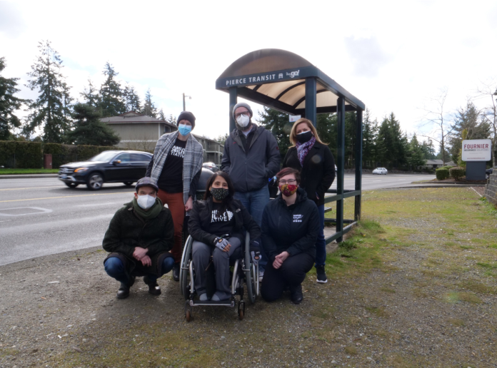 Disability Mobility Initiative A woman in a wheelchair and five other advocates at a Tacoma bus stop.