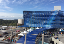 Sound Transit Charts an Expanded Paid Parking Program A four-story parking structure with a blue decorative screen.
