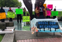 Judge Strikes ‘Compassion Seattle’ City Charter Amendment from November Ballot – Update A photograph showing participants holding colorful signs at a press event. The signs carry messages such as "sweeps cause harm" and "sweeps bring no compassion"