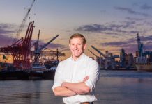 The Urbanist Podcast: The Port of Seattle with Commissioner Ryan Calkins Ryan calkins stands in front of cranes on the Seattle waterfront.