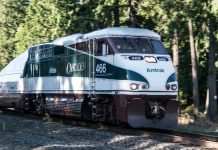 All Aboard Washington Releases New Passenger Rail Vision Map A photo of an Amtrak Cascades locomotive car surrounded by forest.