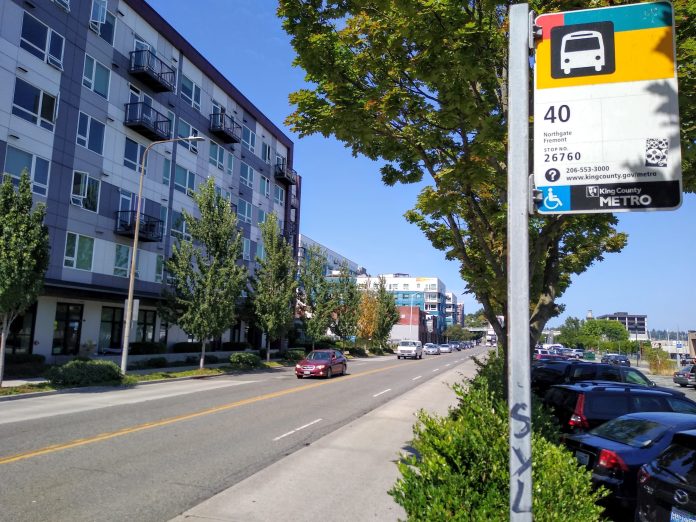 A bus stop along a four lane busy road reading "40"