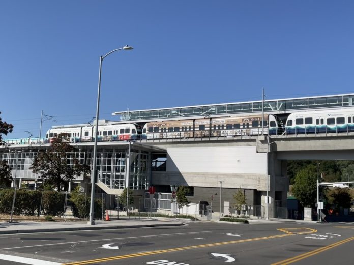 A photo of an elevated Link light rail line over a street.