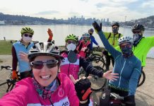 Events, Activities, and Advocacy for Urbanists, September 2021 A group of cyclists wearing colorful athletic clothes poses near their bicycles in front of Lake Union in Seattle.