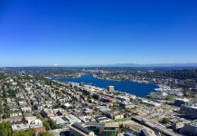 The Benefits of Auctioning Off Development Rights A photo showing an aerial view of Seattle looking north from the Space needle, housing, roads, and Greenlake are all visible.