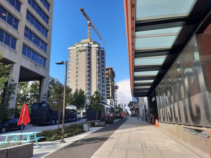 Brooklyn Avenue looking north with UW Tower on the left and a new 24-story tower rising behind the Graduate Hotel.