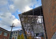 As Seattle Public Library Sees Funding Restored, Survey Seeks Input on Library Hours Exterior of Capital Hill Library with angled glass entry.