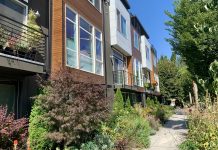 Introducing The Urbanist’s Podcast A photo of townhouses with lush shrubs and trees.