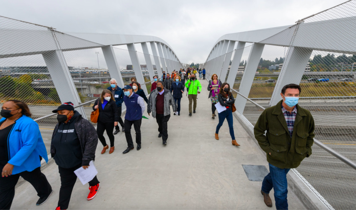 SDOT aerial shot john lewis bridge A photo of people walking on a pedestrian bridge over Interstate 5.