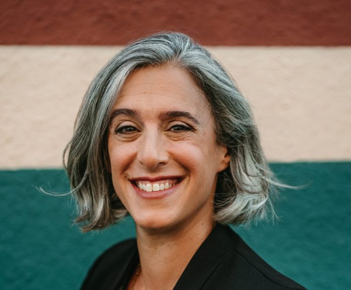 Ilana Preuss Brand Photos A photo a woman with grey hair wearing a black blazer.