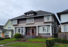 Equity Analysis Favors Broader Home in Tacoma Rezone A photo of a grey triplex with red doors that maintains the scale of a large single family house.