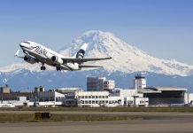 High Speed Rail Is a Solution for Terrible Airlines Alaska Airlines plane takes off from Seattle-Tacoma International Airport with Mt. Rainier in the background.