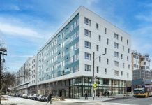 Housing Benefit Districts Could Create Millions of Affordable Homes a photo of a modern aqua and white five story apartment building