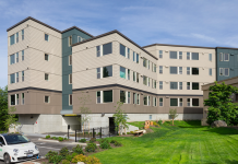 Bellevue Council Update: Juneteenth Holiday, Regional Affordable Housing Funds, and Eviction Resolution A view of a an apartment building in front of a green lawn.