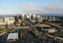 Bellevue Council Update: An Important Restart for Wilburton Transit Oriented Development Planning A photo of a city with light rail under construction, streets, and tall modern buildings in the distance