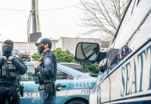 Op-Ed: New Drug Bill Relies on Trusting a Contemptuous Seattle Police Force Three officers standing around a squad car