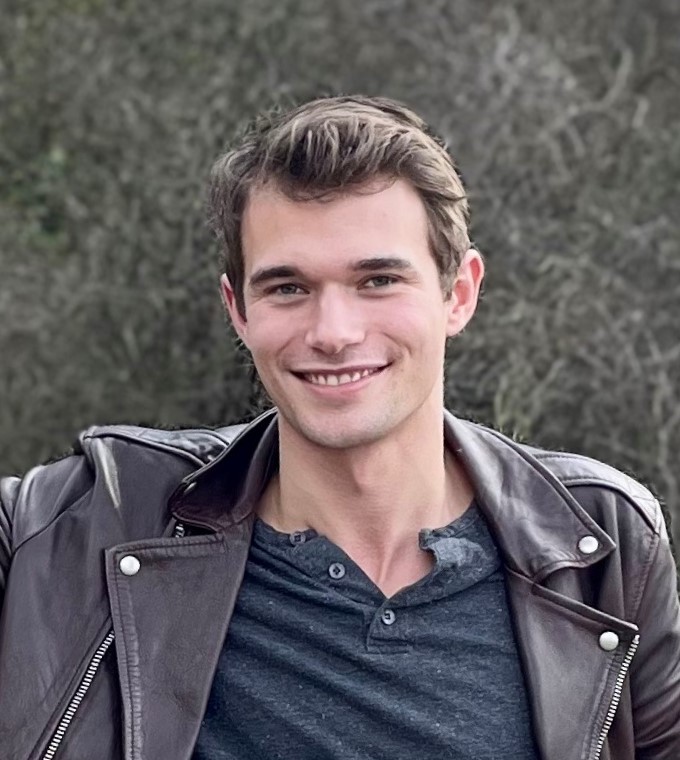 Jesse Simpson bio photo_cropped Jesse Simpson in a leather jacket