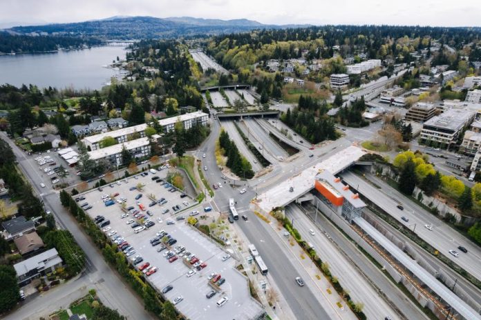 Mercer Island's light rail station, in the median of I-90, being constructed. Parking lots and low density development is visible on the periphery