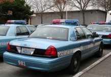 Public Safety Politics and the Even Election Reckoning A light blue SPD police cruiser in a parking lot.