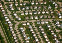 Urbanism 101: Zoning’s History and Role in the Housing Crisis An aerial shot of cookie cutter houses in a subdivision.