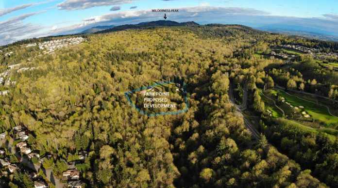 created by dji camera An aerial view of forested land with a circle indicating the 12 acres planned for single-family home development.