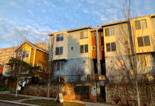 Micro-Apartments May Be Bellevue’s Next Affordability Move Microhousing building next to a single family home. Blue sky overhead and sunset lighting.