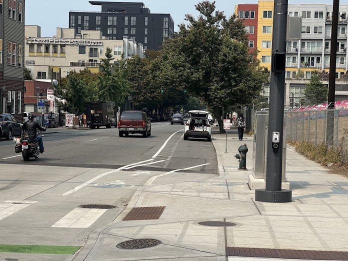 Western Ave CarsInBikeLanes SandersLauture Looking down Western Avenue at a white car in the bike lane.
