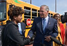 Seattle-Area Schools Slowly Electrify Bus Fleets Governor Inslee shakes the hand of a Tacoma high school student standing in front of the state's first electric school bus in 2019.