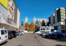 Washington State Senate Approves Sweeping Parking Reform Bill A parking lot in Belltown with towers behind