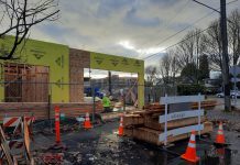 Op-Ed: Impact Fees Are Just Another Exclusionary Housing Policy in Disguise A construction worker gathers supplies as the light filters through the clouds. One story of the four story building is complete at this point.