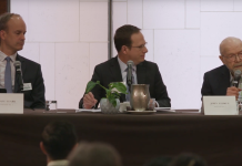 Bellevue Council Hopefuls Square Off at Forums on Safety, Environment, and Downtown Men in suits at a table with a white background.