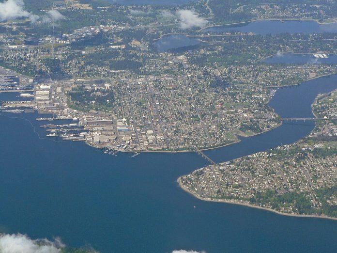 1440px-Bremerton_07758 An aerial photograph shows the port city of Bremerton from a height of nearly 10,000 feet.