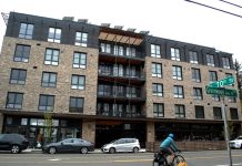 Phinney Ridge Apartment Complex Pioneers Unique Communal Model A bike whizzes by on Greenwood Avenue with a brick building in the background